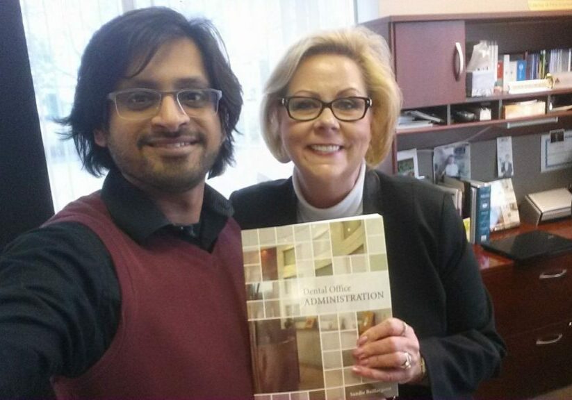 Dr. Abbas and Sandy. Sandy is holding first edition of her textbook.